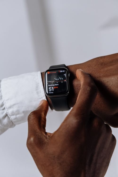 Person wearing a smartwatch showing a health tracking app